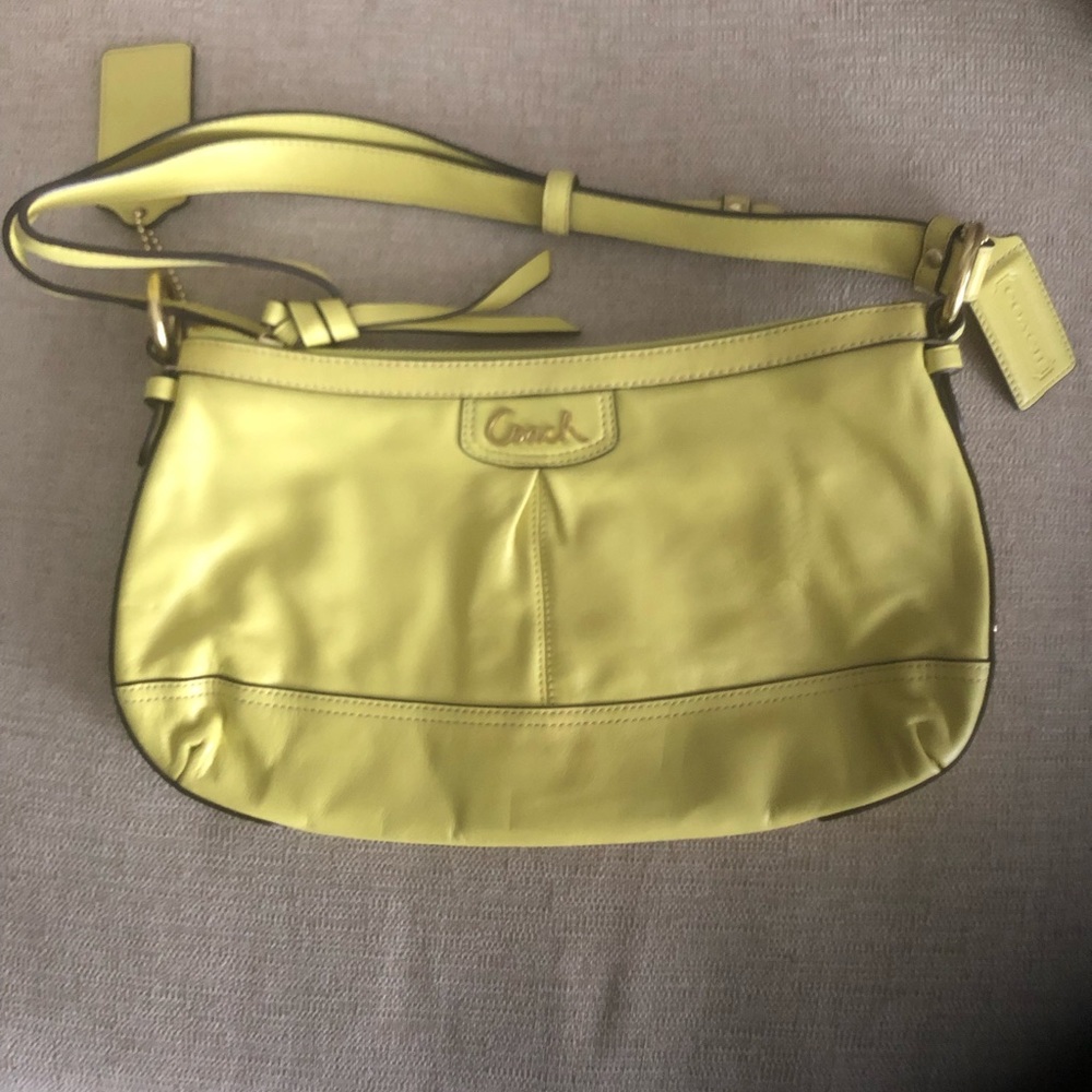 Brand new/never used Coach purse! Beautiful yellow color in perfect condition.